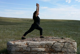 Doing the “crescent lunge” on a rock that bison at OMB rub themselves on (Photo by NCC)